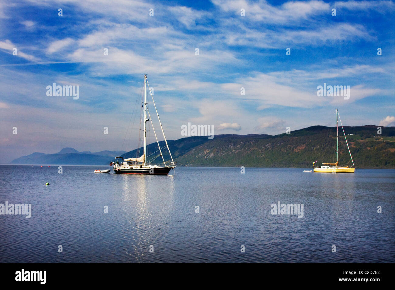 Yachts anchored on Loch Ness near to The Dores Inn and Dores Village.  Stock Photo