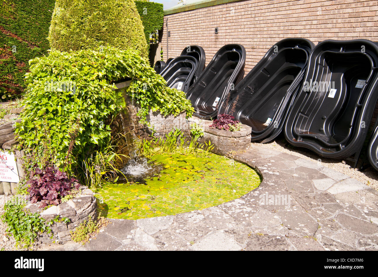 Display of black plastic moulds for pond building at garden centre, UK Stock Photo
