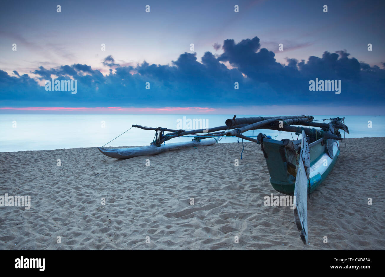 Oruwa (outrigger canoe) on beach at sunset, Negombo, North Western Province, Sri Lanka, Asia Stock Photo