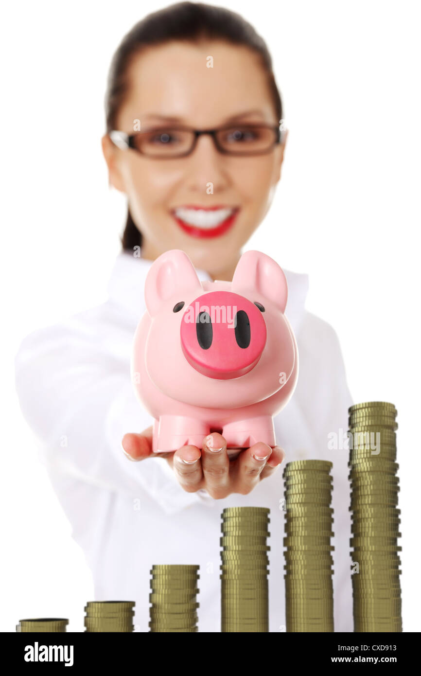 Happy business woman with her savings in a piggy bank - isolated on ...