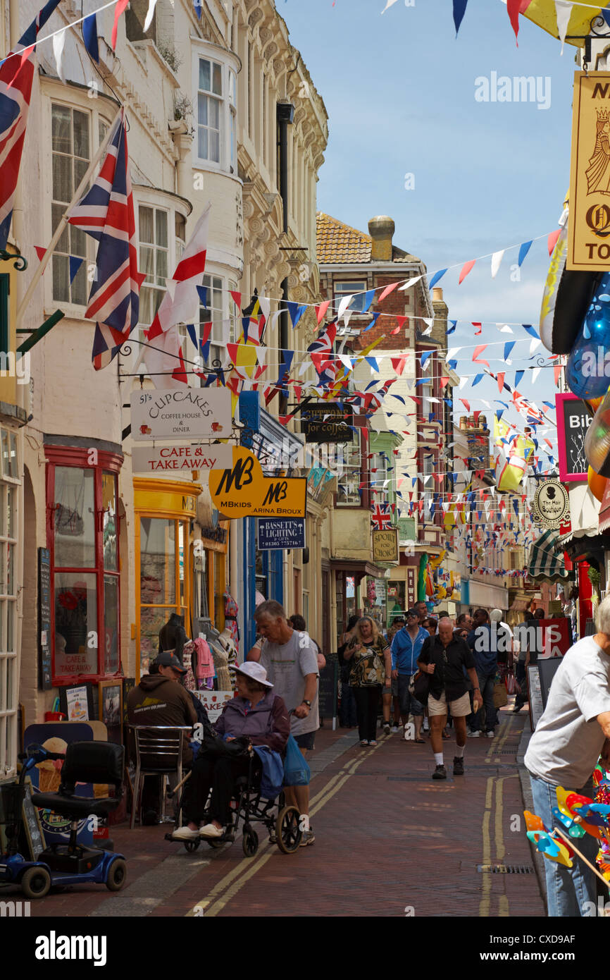 Busy street in Weymouth with bunting flowing in July Stock Photo