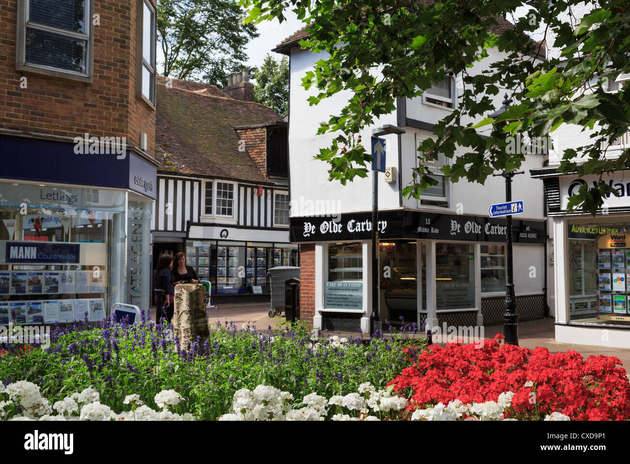 Flowerbed and Ye Old Carvery shop selling take away food in town centre in summer. Middle Row High Street Ashford Kent England UK Stock Photo