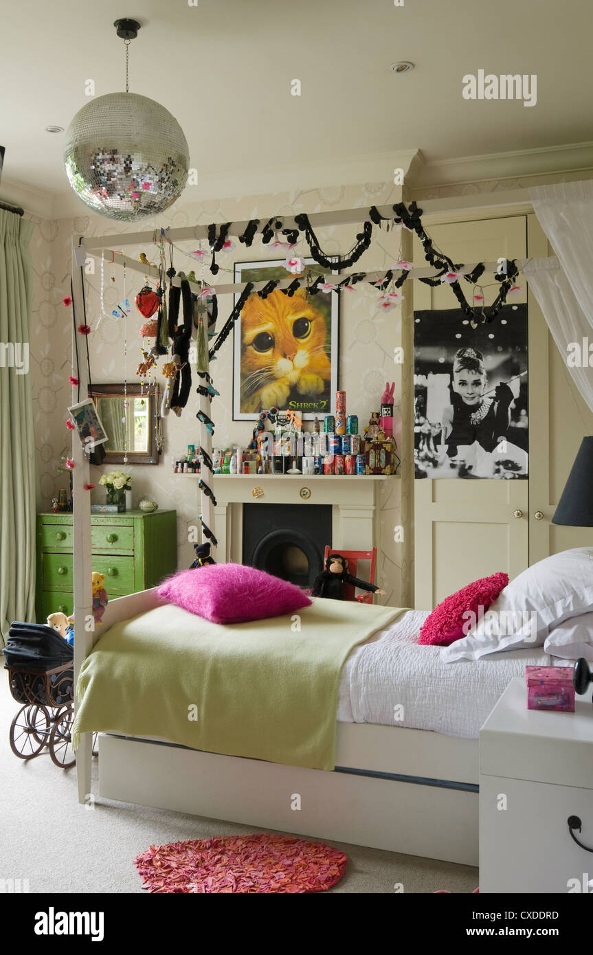 Single four poster bed in teenage girl's bedroom Stock Photo