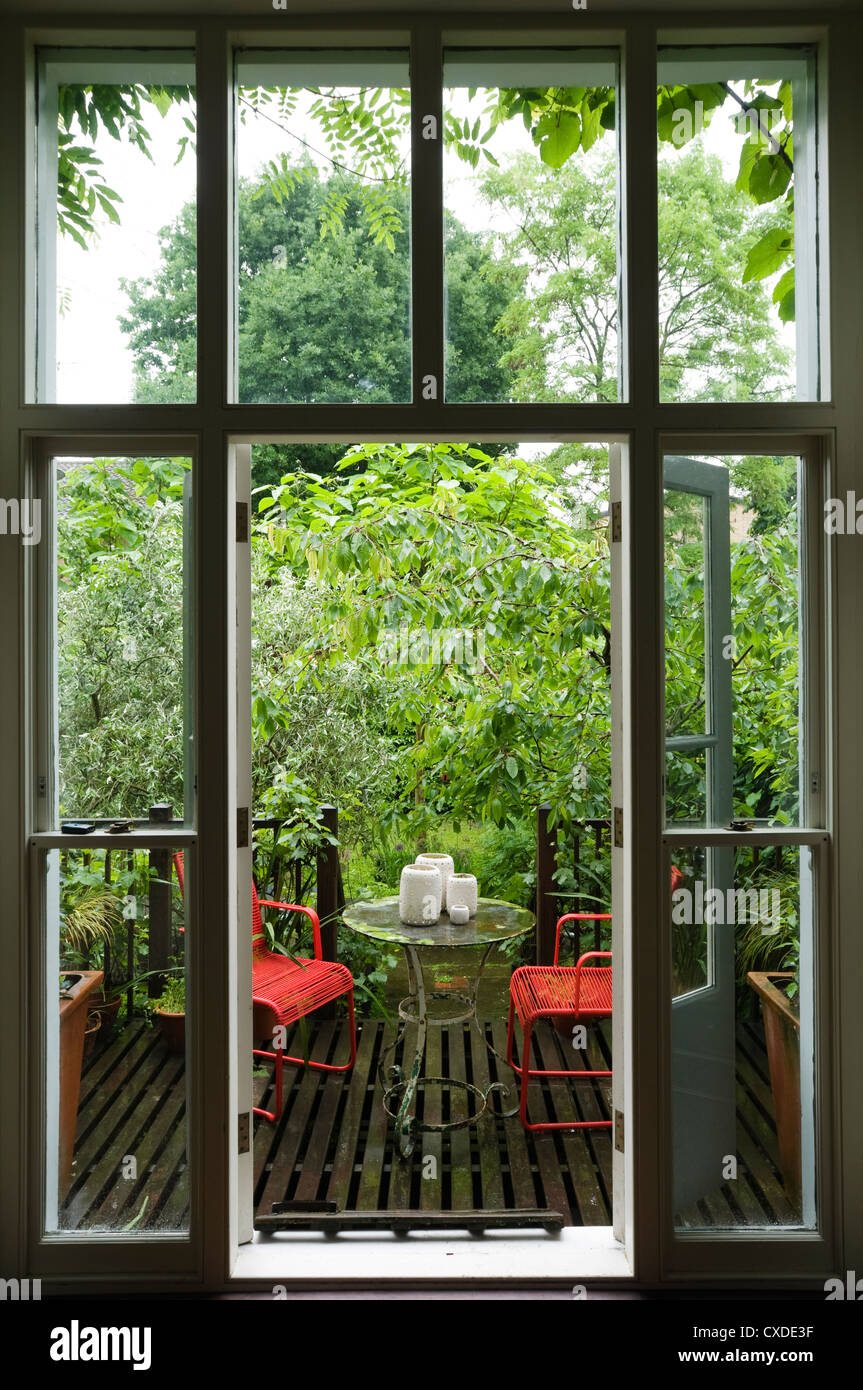 Outdoor seating on decking of London townhouse after rain Stock Photo