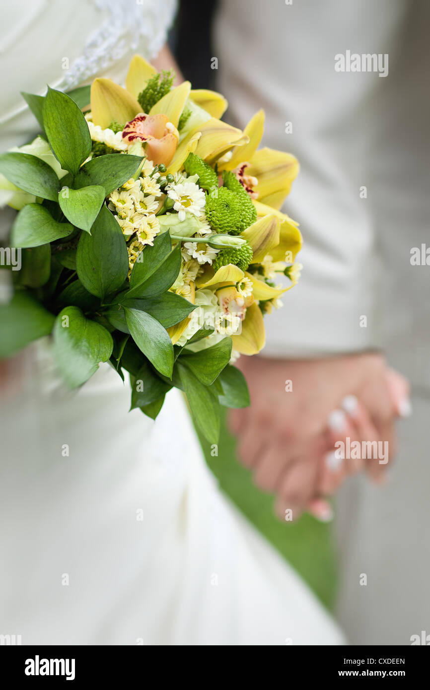 Detail of hands of wedding couple with wedding bou Stock Photo