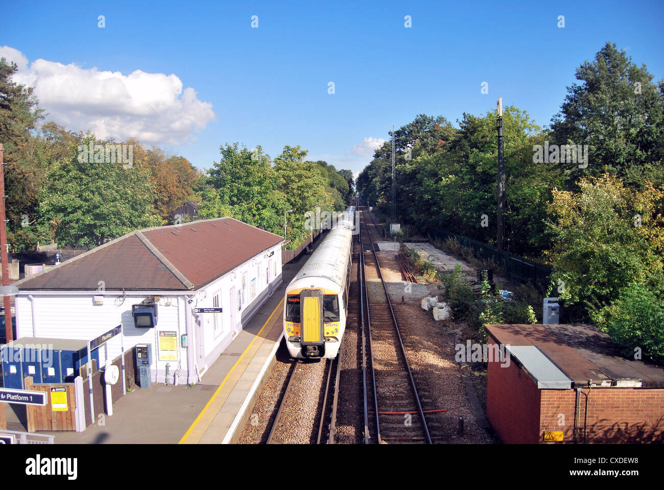 A train operated by south eastern railway departs from Pluckley railway ...