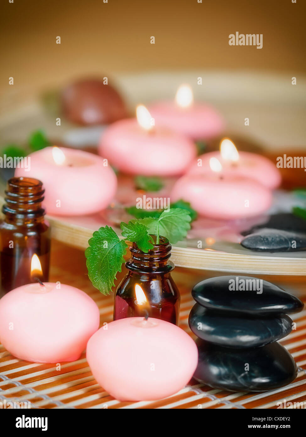 Pink candles, stones, and essential oil. Stock Photo