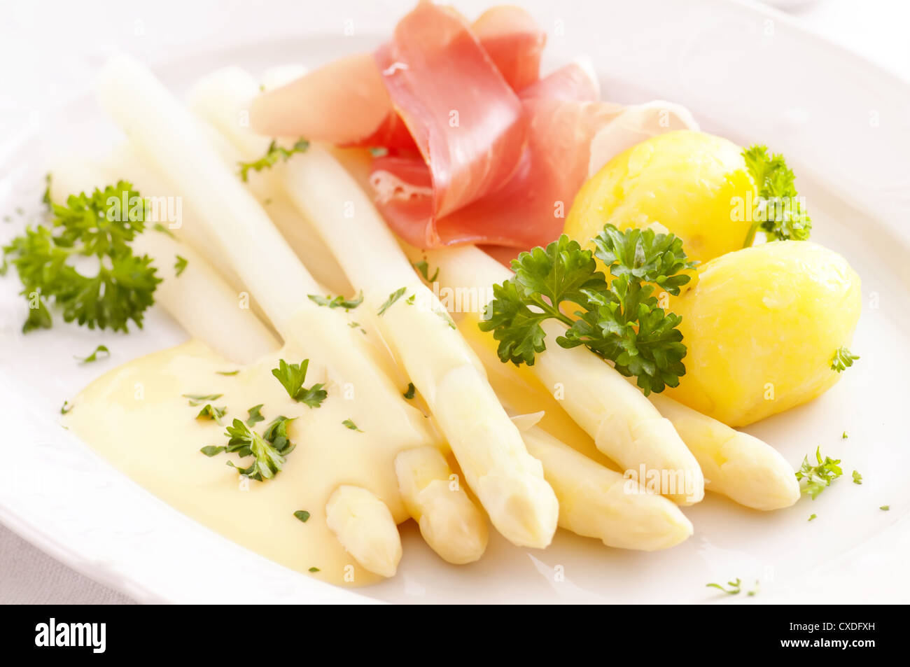 Asparagus with potato and gammon Stock Photo