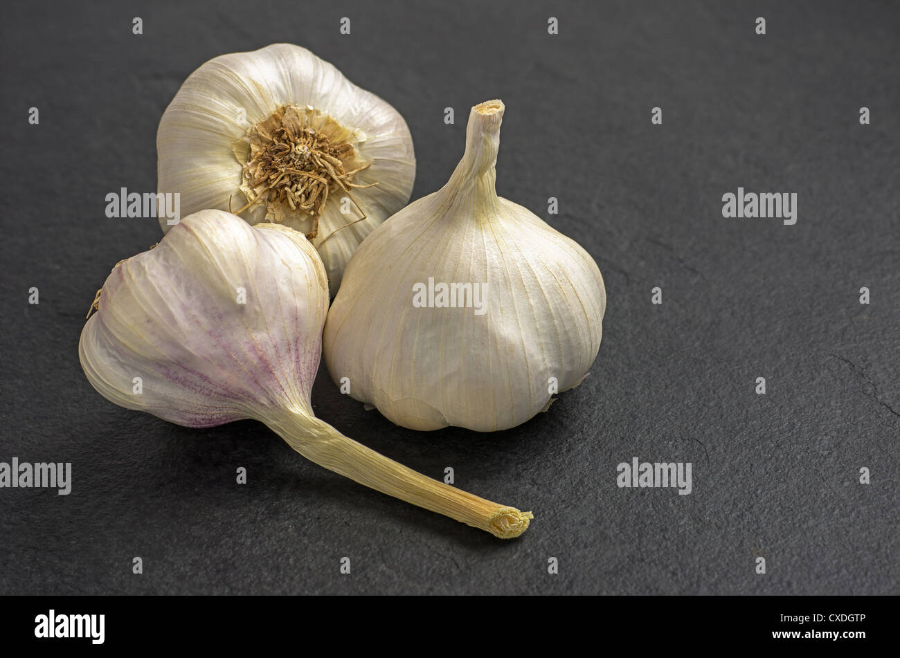 garlic on slate plate Stock Photo