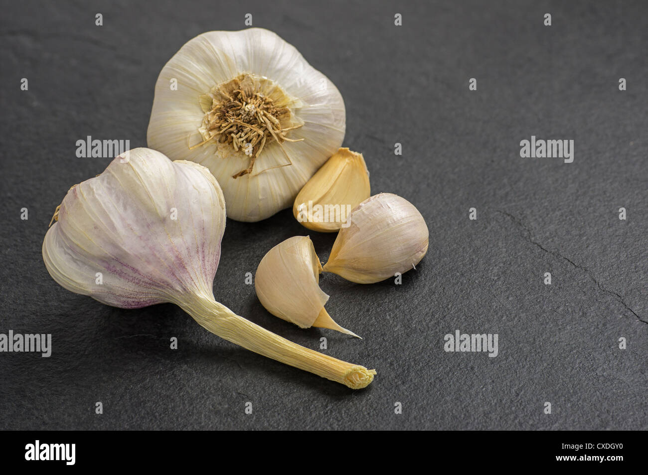 garlic on slate plate Stock Photo