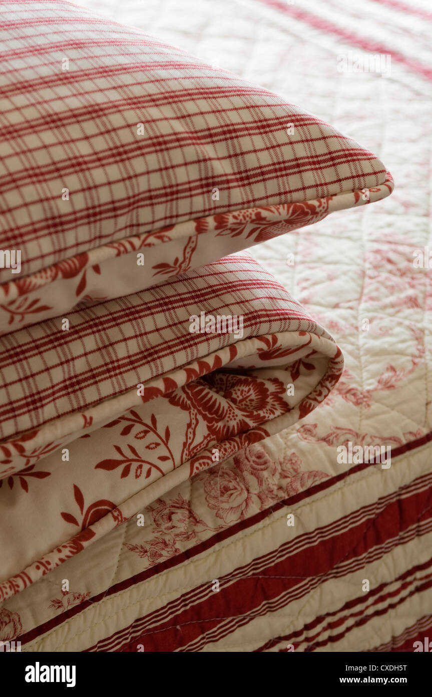 Folded Duvet Covers In Red Checked And Floral Patterned Fabric