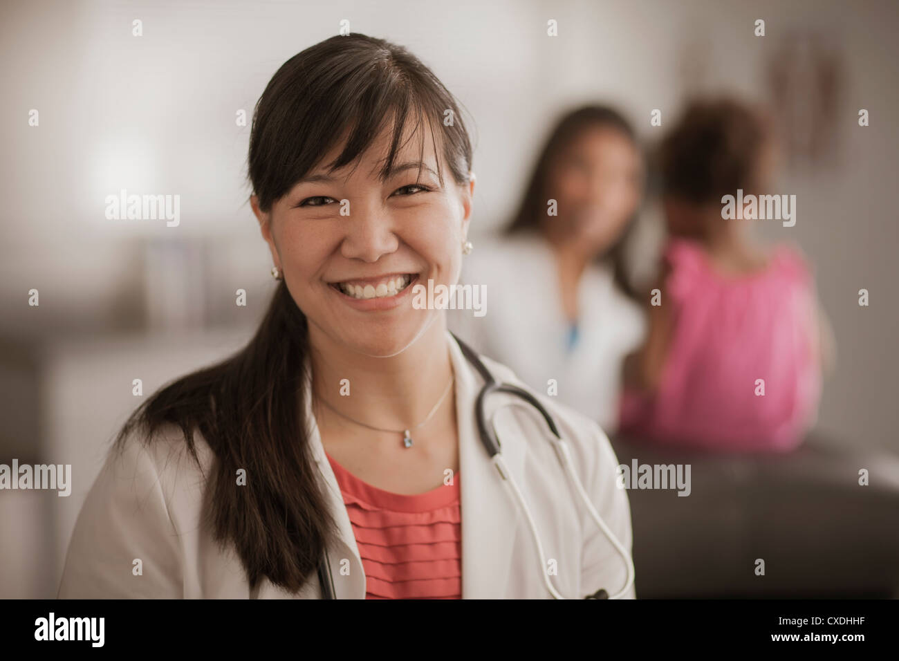 Smiling Chinese doctor in doctor's office Stock Photo Alamy