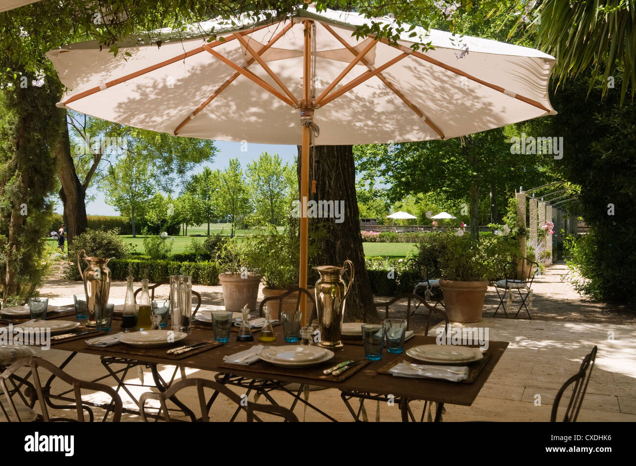 Parasol and dining area in grounds of Provence country house Stock Photo