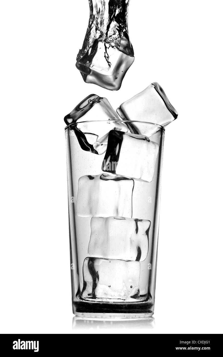 ice cubes dropped into glass with bubbles isolated on white Stock Photo ...
