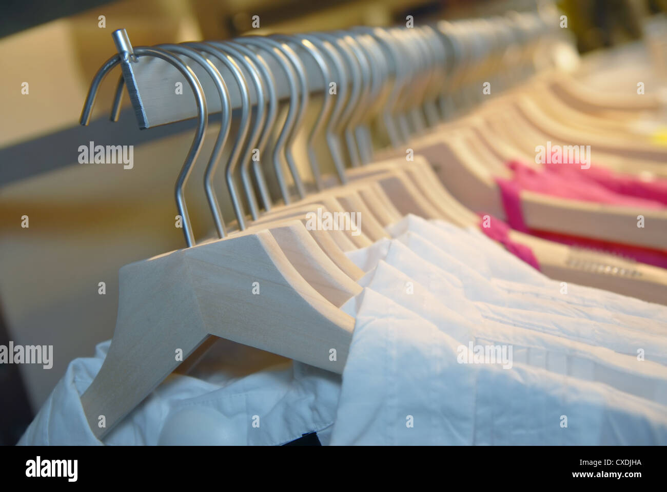 clothes on racks in store Stock Photo Alamy