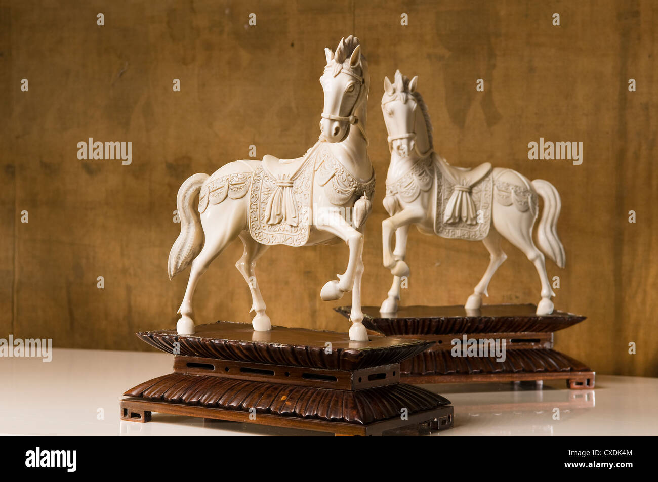 Pair of Chinese carved ivory caparisoned horses on hardwood bases Stock Photo