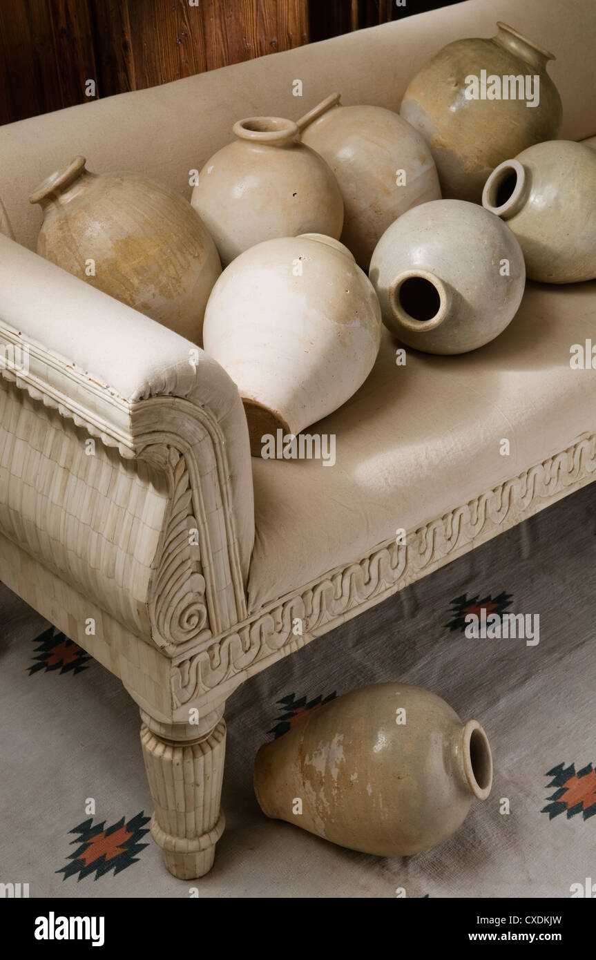 Bone veneer sofa with Tang dynasty part glazed ovoid jars Stock Photo