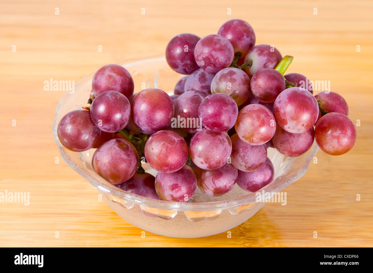A cluster of grape grapes in glass bowl Stock Photo Alamy