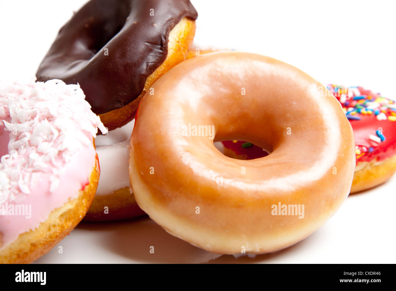 A stack of fresh decorated donuts on a white background Stock Photo - Alamy