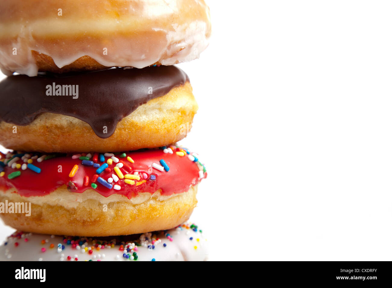 A stack of fresh decorated donuts on a white background Stock Photo - Alamy