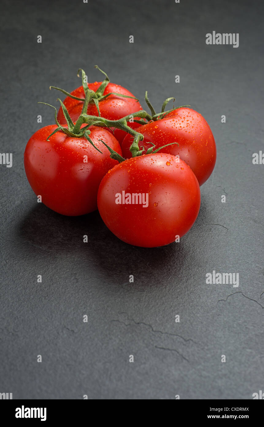 tomatoes on slate plate Stock Photo
