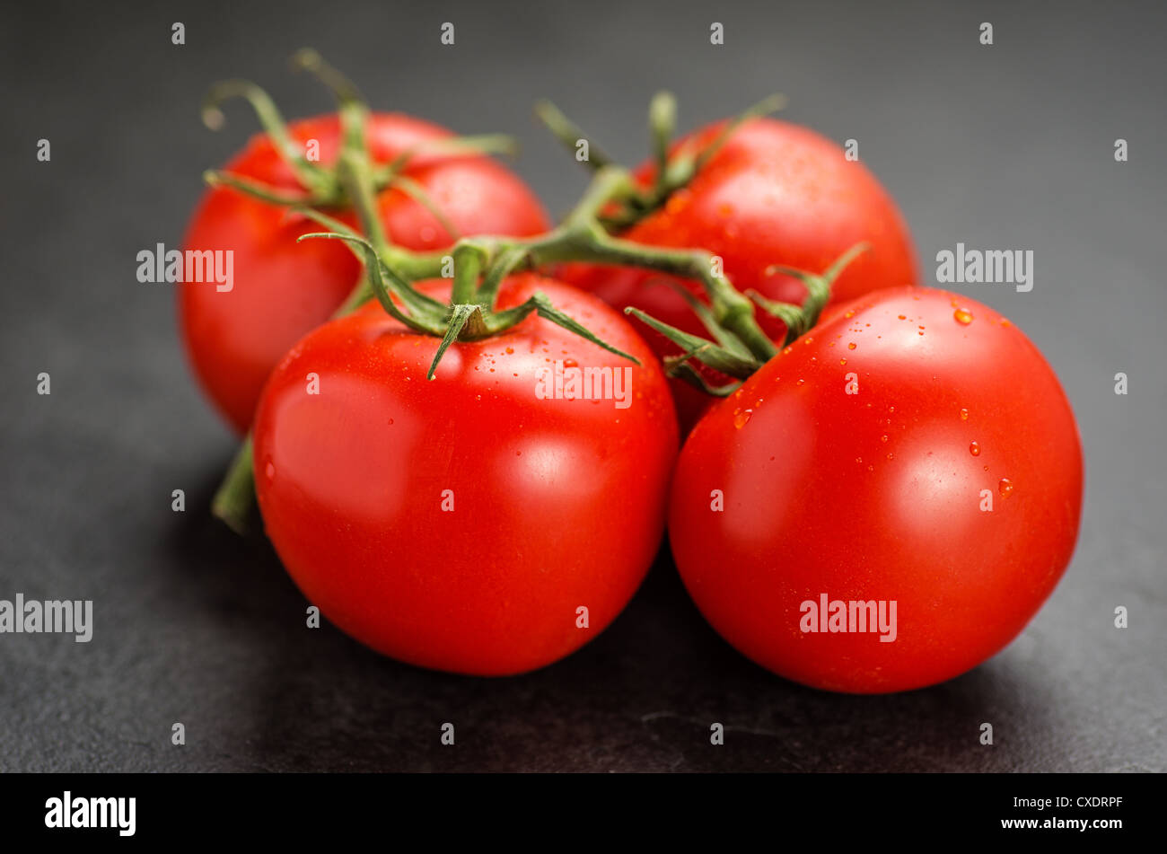 tomatoes on slate plate Stock Photo