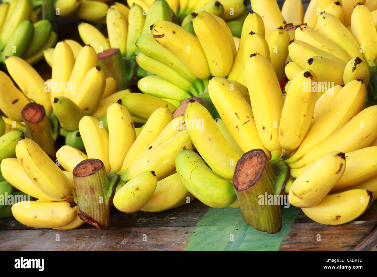 Banana bunch group on desk in market Stock Photo - Alamy