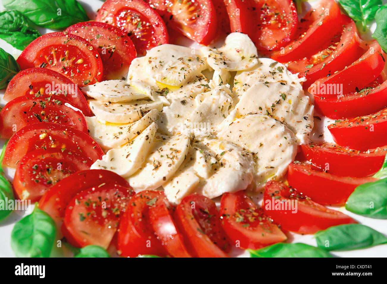 mozzarella with basil and tomatoes with olive oil Stock Photo - Alamy