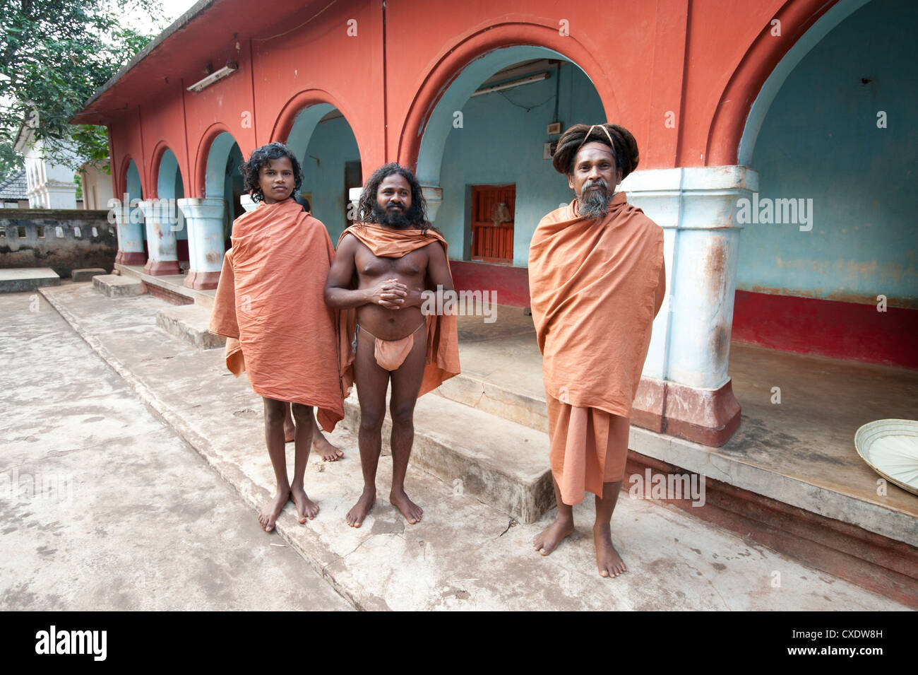 Barefoot Joranda monks wearing orange cloths in a monastery building, Joranda, Orissa, India, Asia Stock Photo