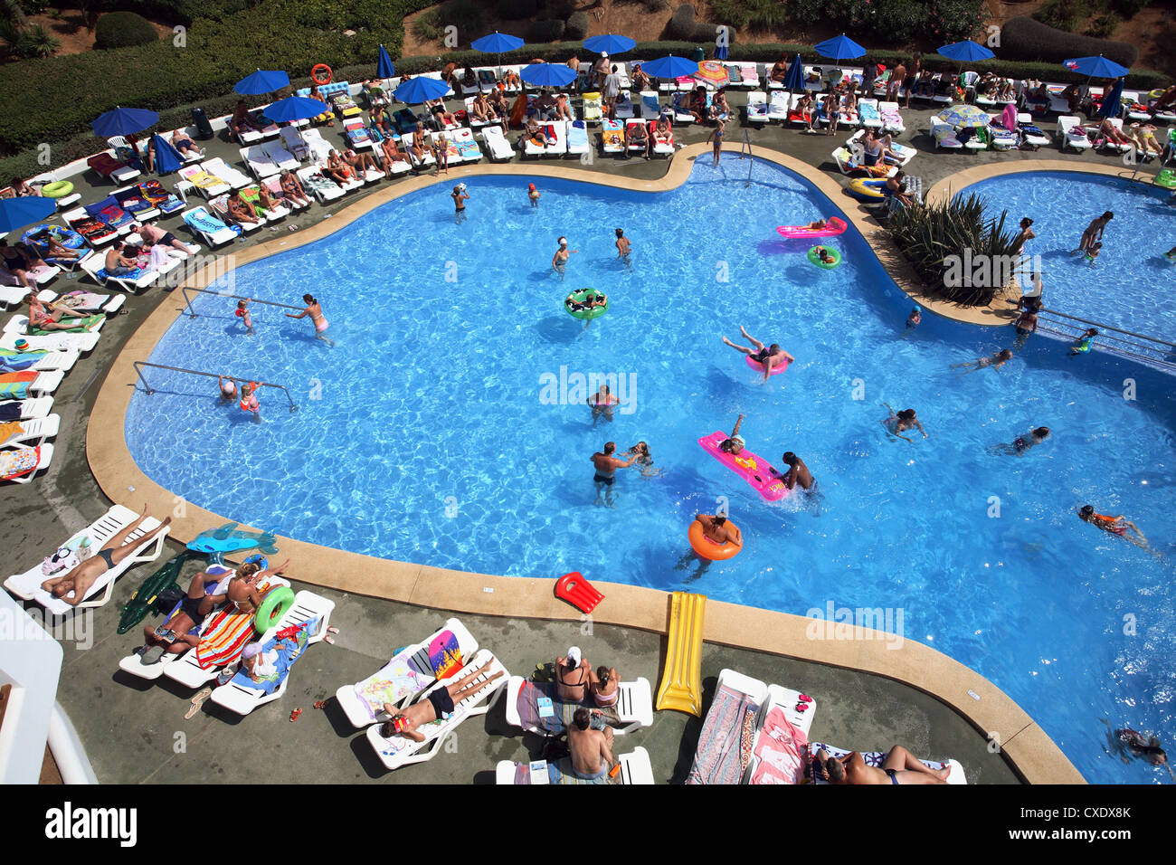 Cala Esmeralda, people at the swimming pool of a hotel Stock Photo