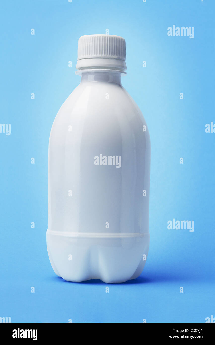 White Plastic Bottle on Blue Background Stock Photo