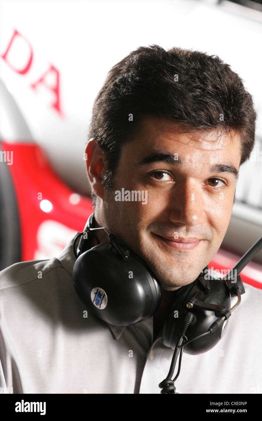 Mechanic stood in front of racing car Stock Photo