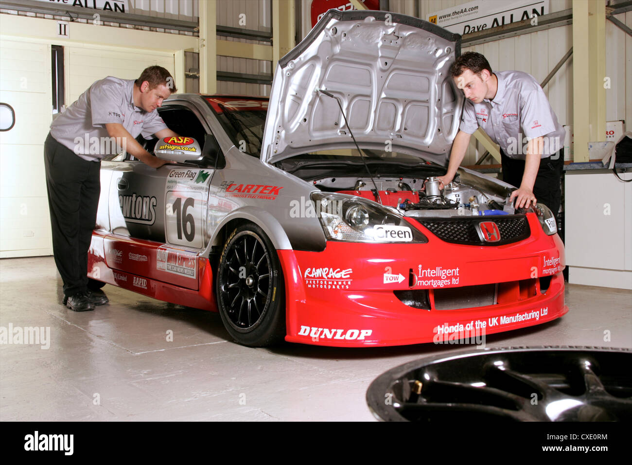 Mechanics working on race car Stock Photo Alamy