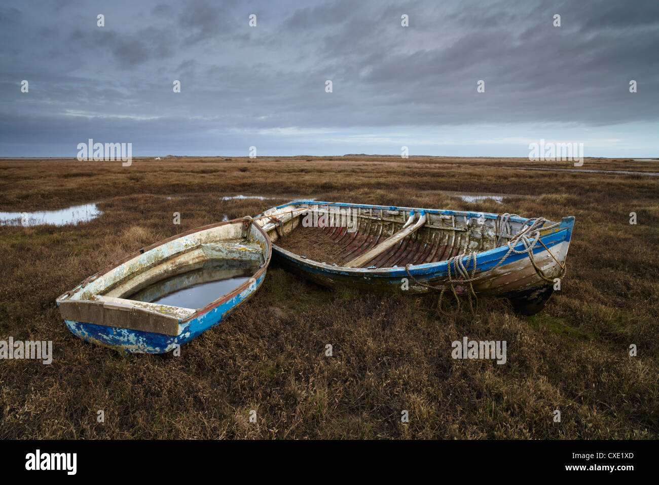 Two old boats on the saltmarshes at Burnham Deepdale, Norfolk, England Stock Photo