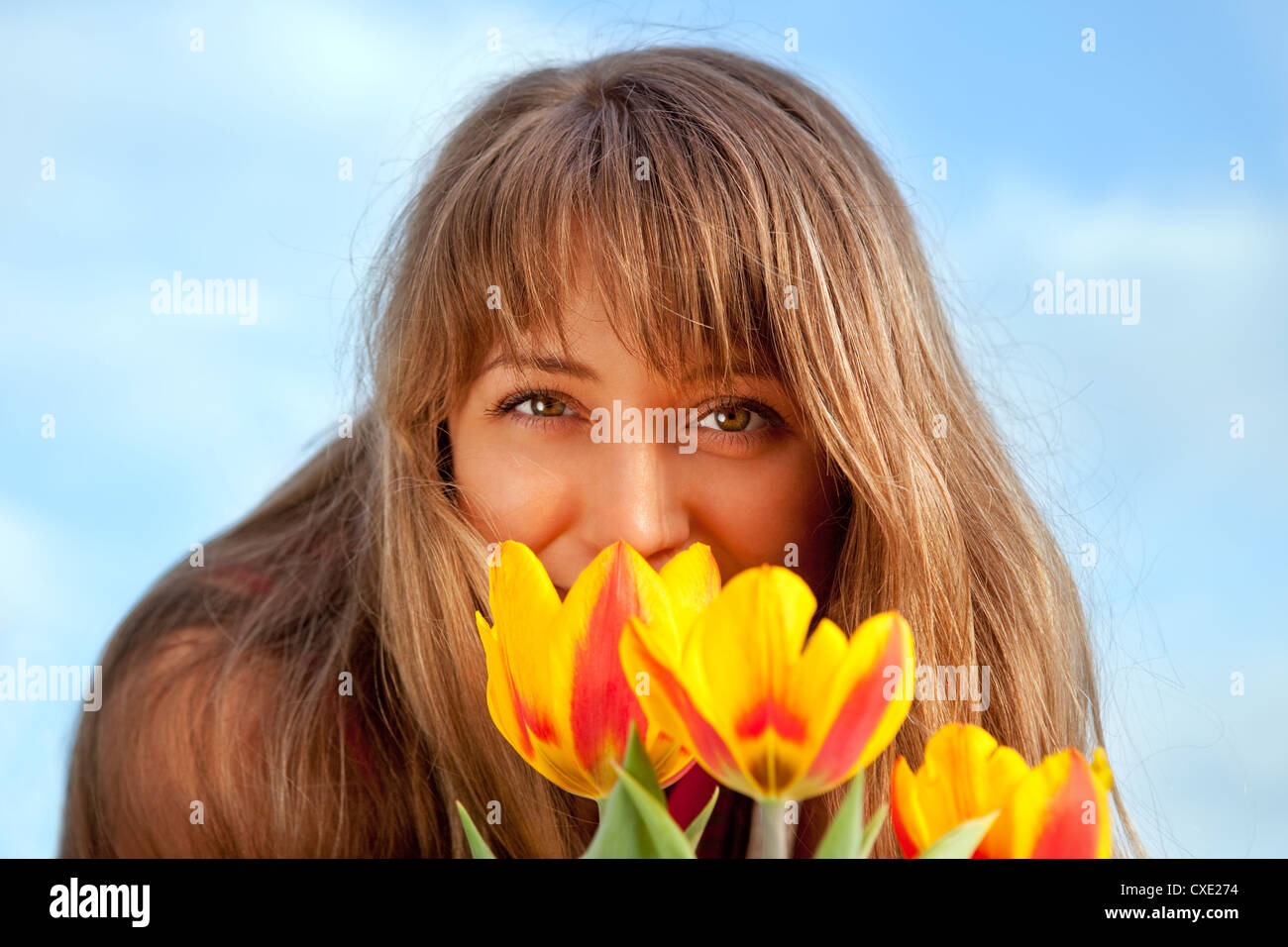 beautiful spring portrait with tulips Stock Photo - Alamy