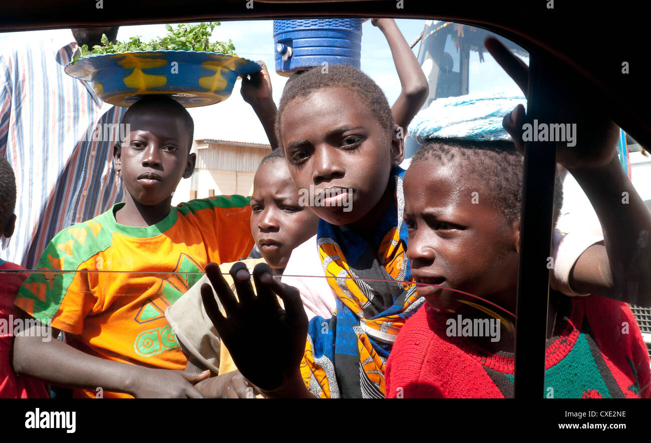 Four young boys looking for gifts through a car window on the