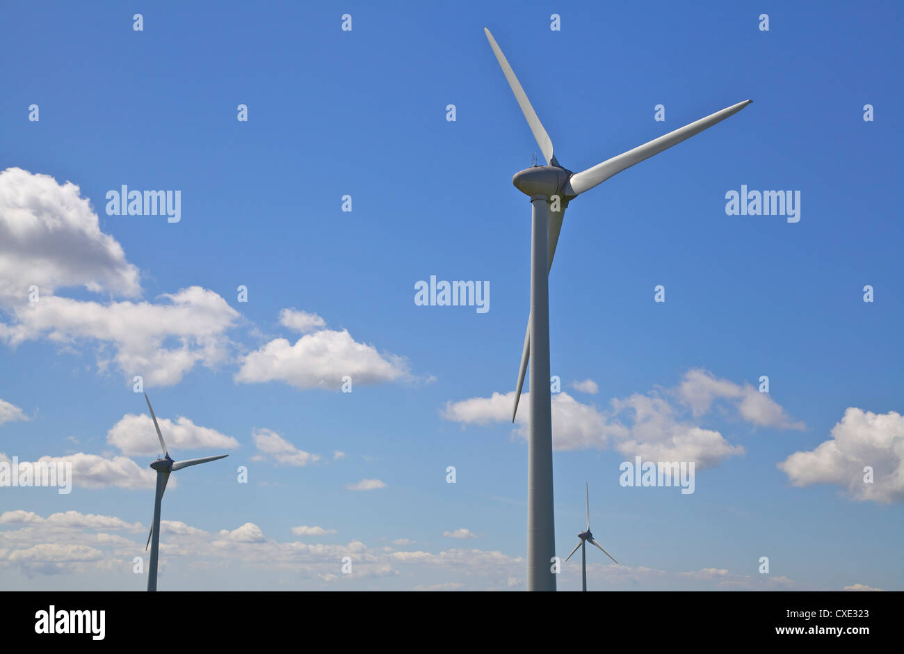 A Wind Turbine farm with a blue sky Stock Photo - Alamy