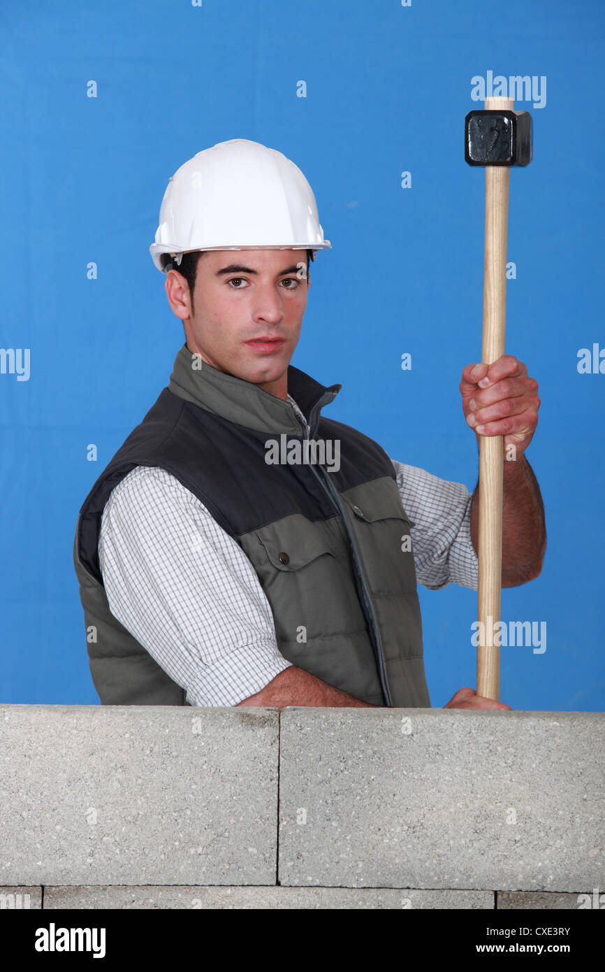 Workman with a sledgehammer Stock Photo Alamy