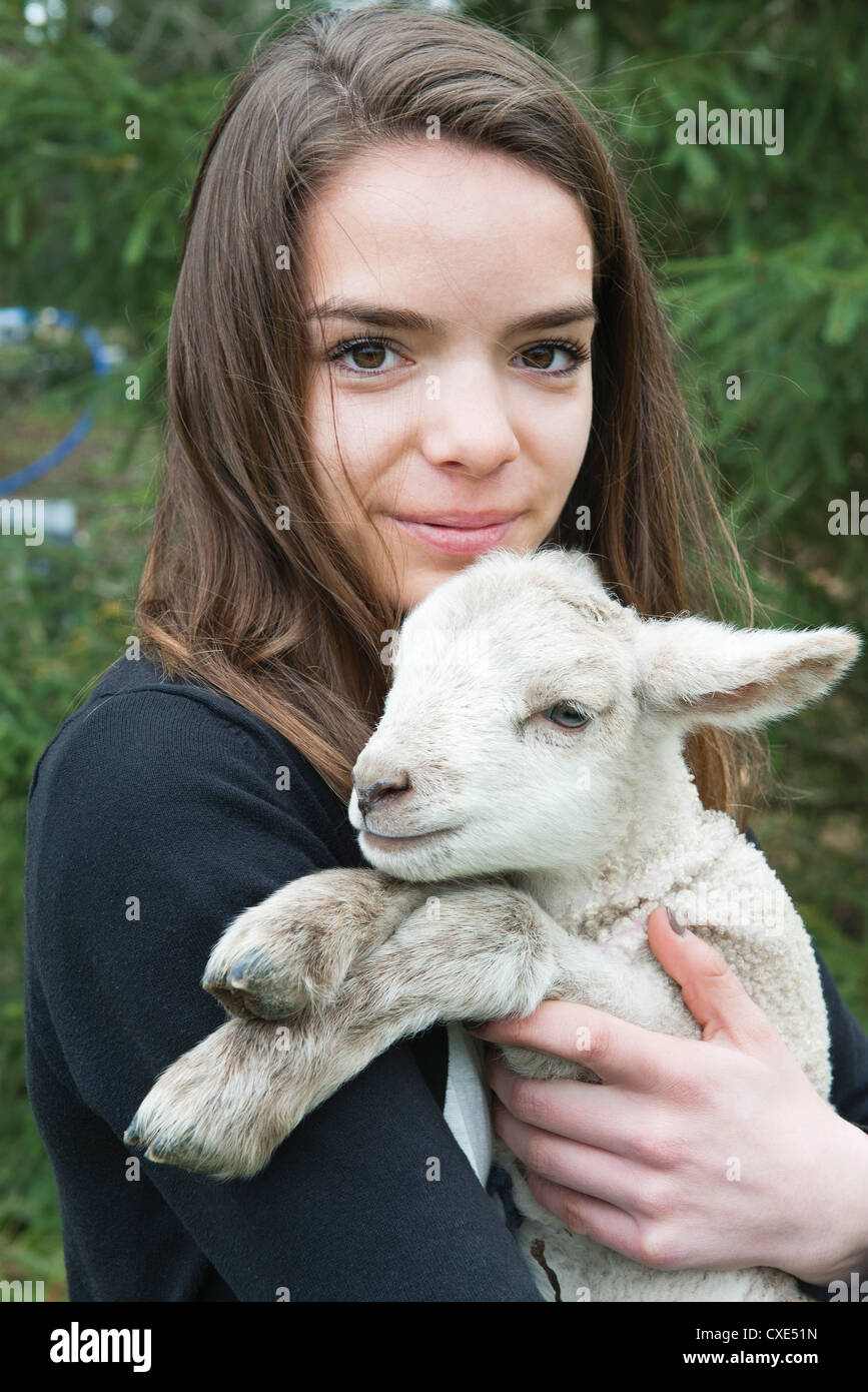 Teenage girl holding lamb Stock Photo