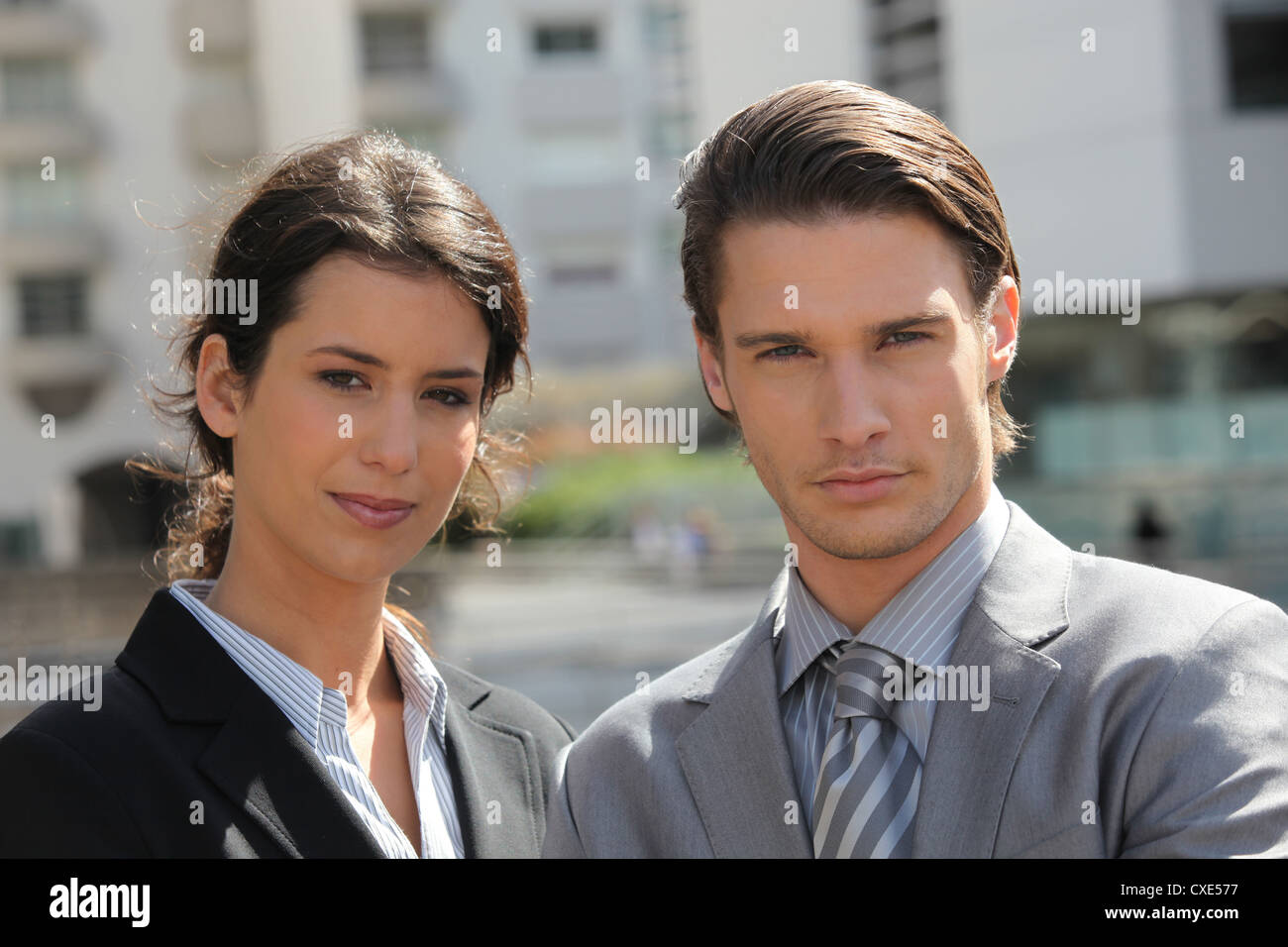 Business couple standing outside Stock Photo - Alamy