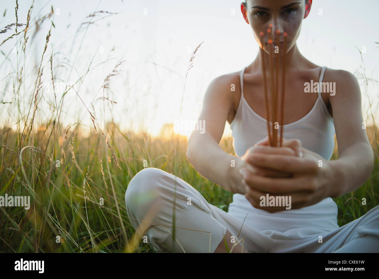 Woman praying in front incense hi-res stock photography and images - Alamy