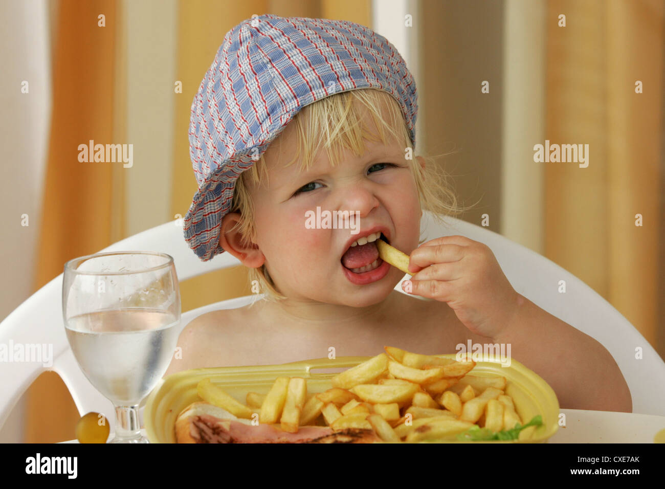 Pajara, a small child eating french fries Stock Photo