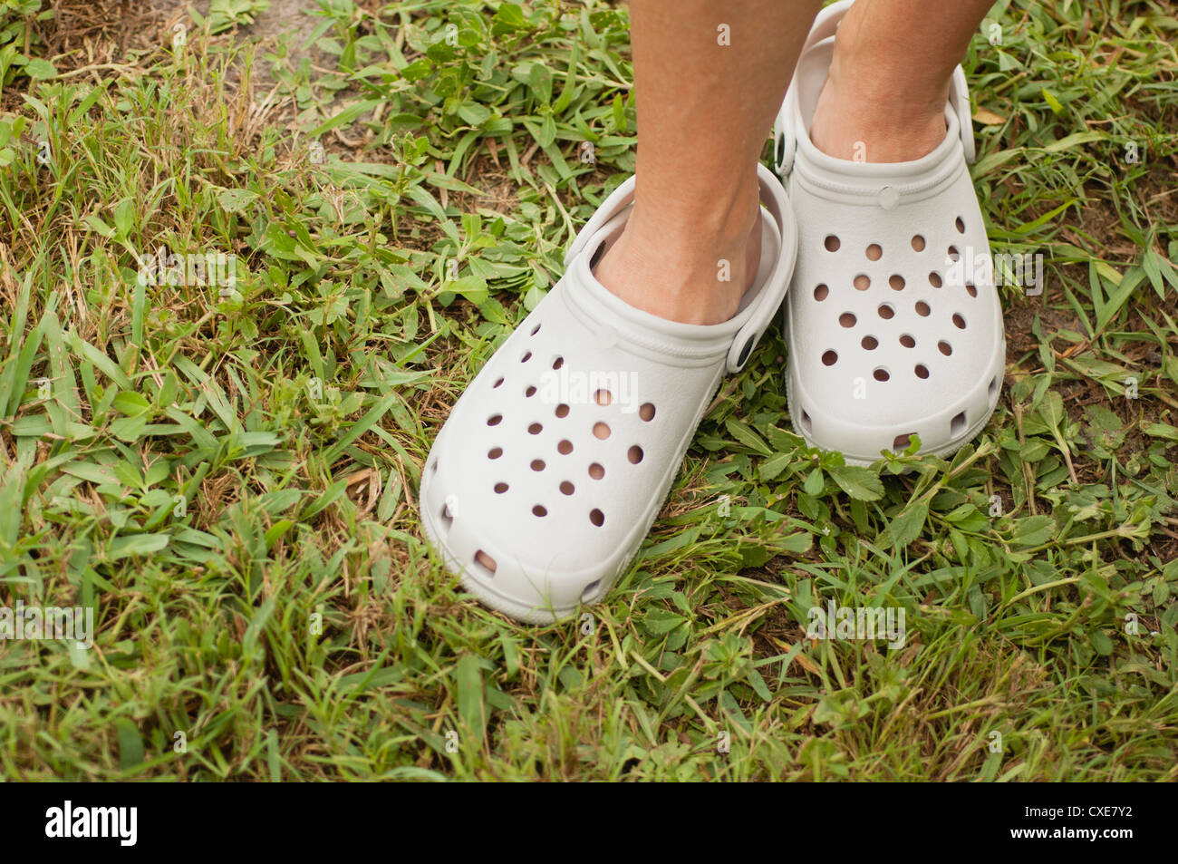 Woman wearing plastic gardening clogs, cropped Stock Photo Alamy
