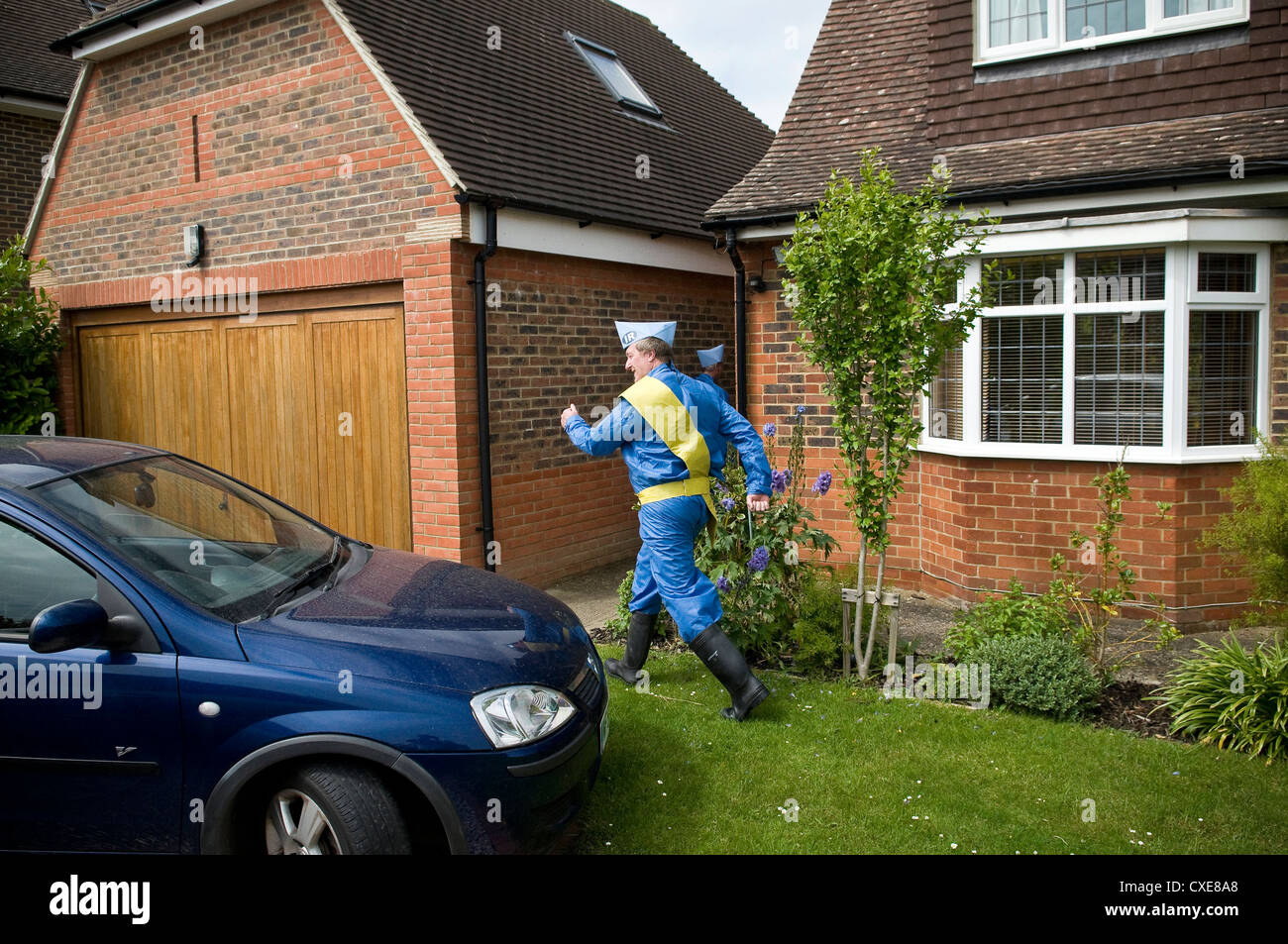 Two Middle-aged men dressed as Thunderbirds puppets in suburbia Stock Photo