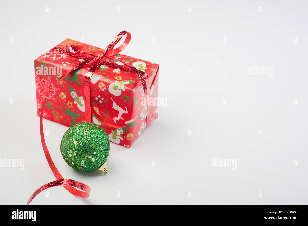 Christmas ornament and festively wrapped present Stock Photo
