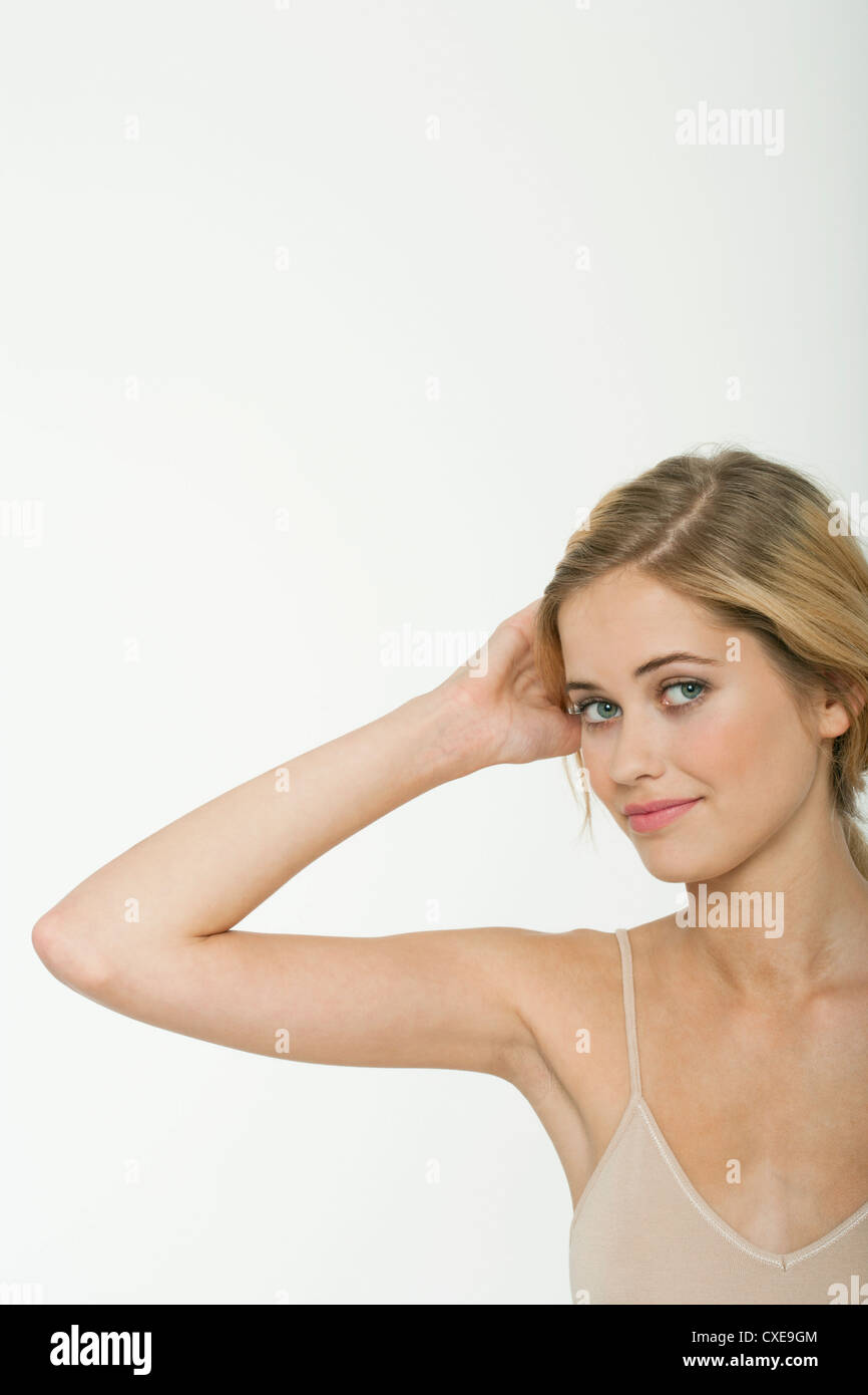 Teen girl with hand in hair, portrait Stock Photo