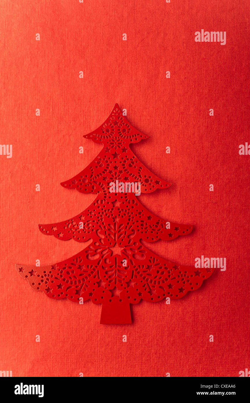 Christmas tree shape on red background Stock Photo
