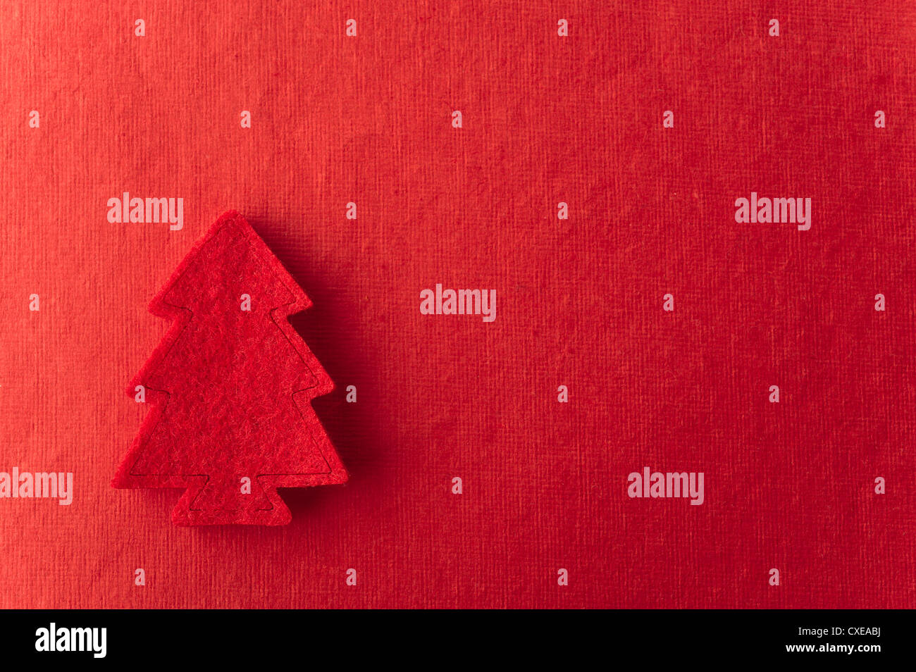 Christmas tree shape on red background Stock Photo
