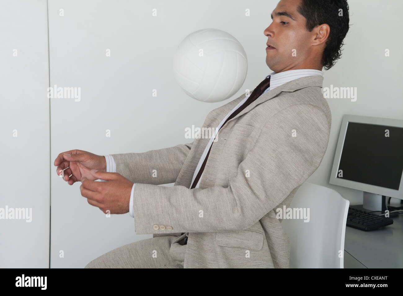 Man playing with ball in office Stock Photo - Alamy