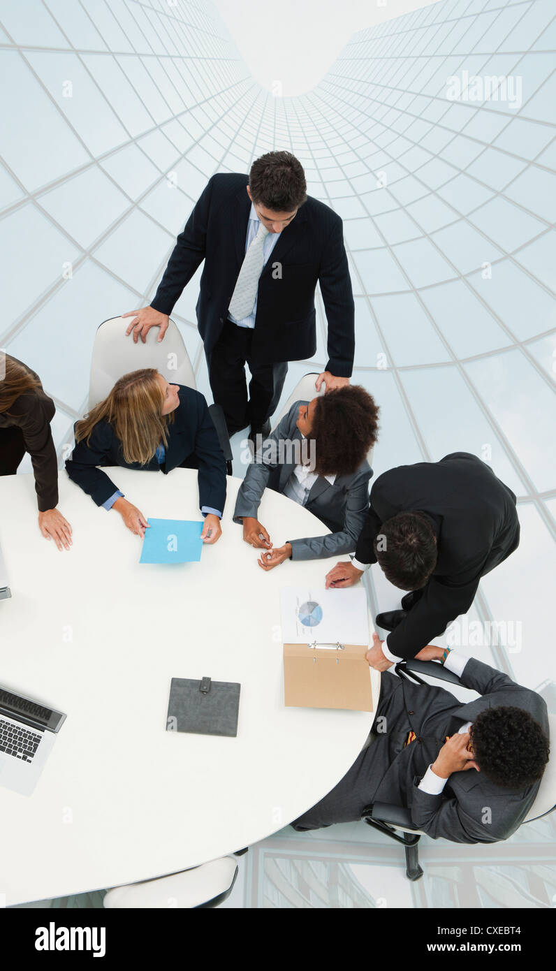 Business associates in meeting on top of superimposed skyscraper image Stock Photo